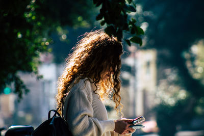 Woman using mobile phone outdoors