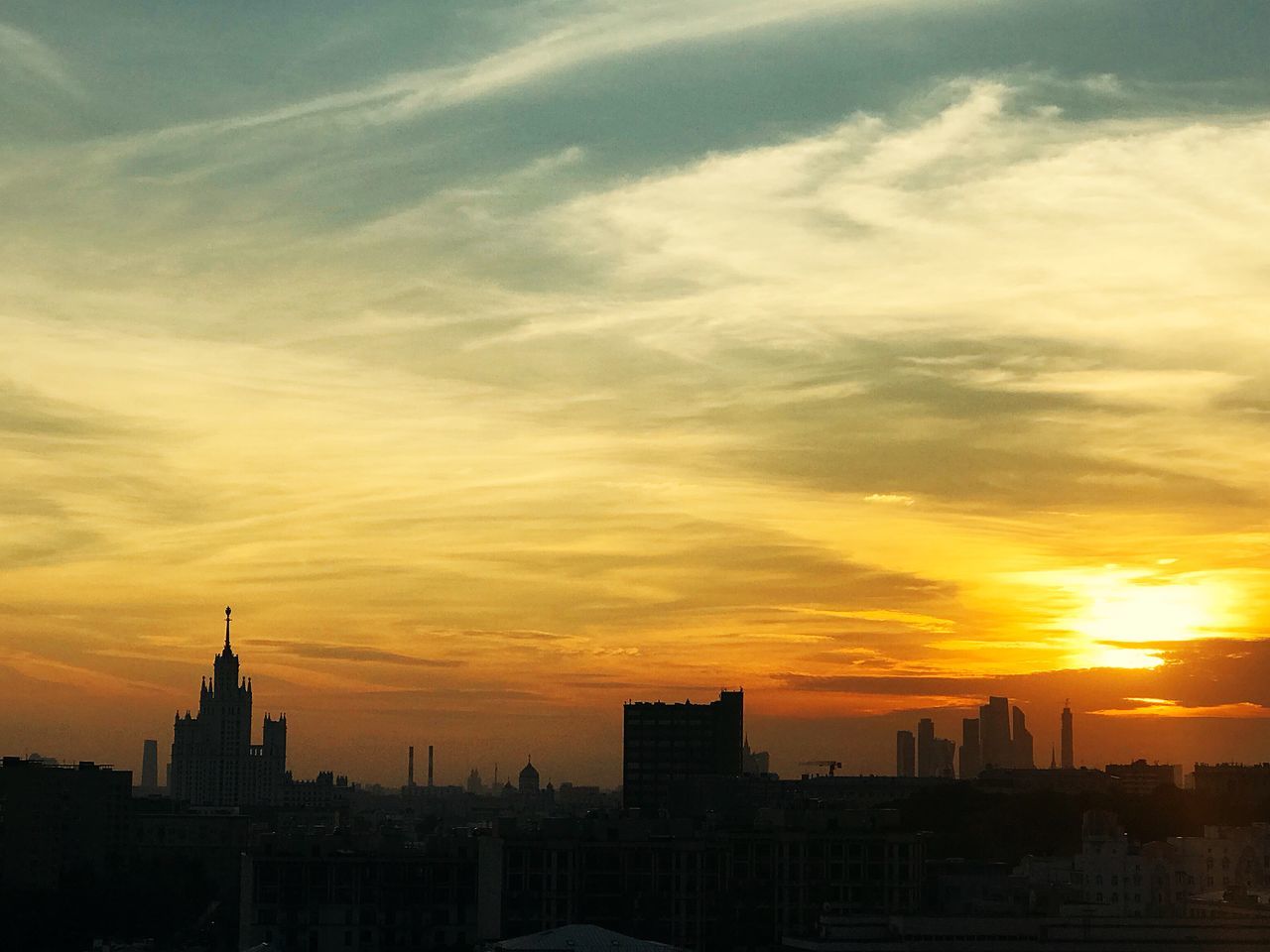 SILHOUETTE BUILDINGS AGAINST SKY DURING SUNSET