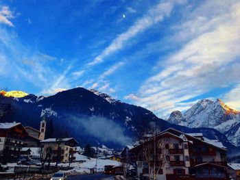 Townscape by mountains against sky