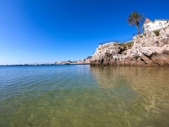 Scenic view of sea against clear blue sky