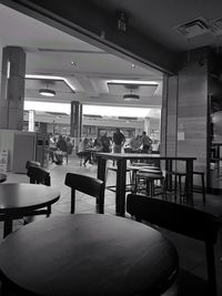 Empty chairs and tables in restaurant