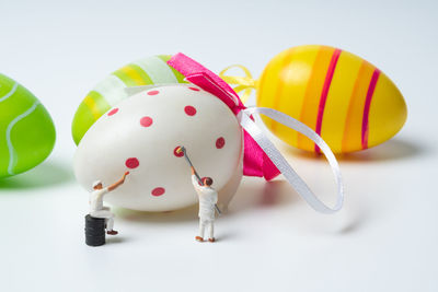 Close-up of multi colored toys against white background