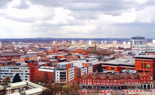 High angle view of city against cloudy sky