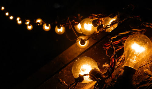 Lit candle in dark room