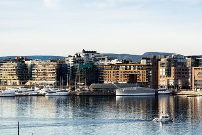 View of buildings at waterfront against sky