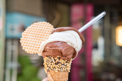 Close-up of hand holding ice cream cone