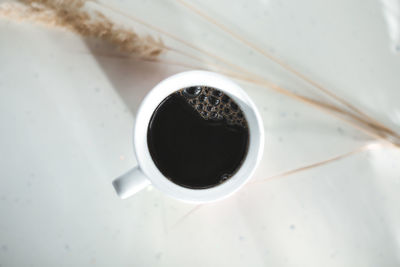 High angle view of black coffee on table