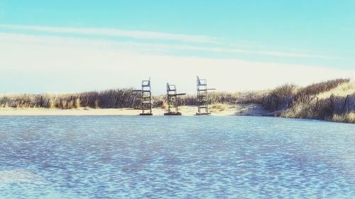 Scenic view of frozen field against sky during winter