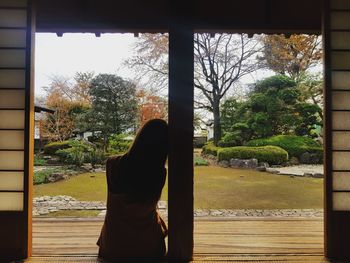 Woman standing by window