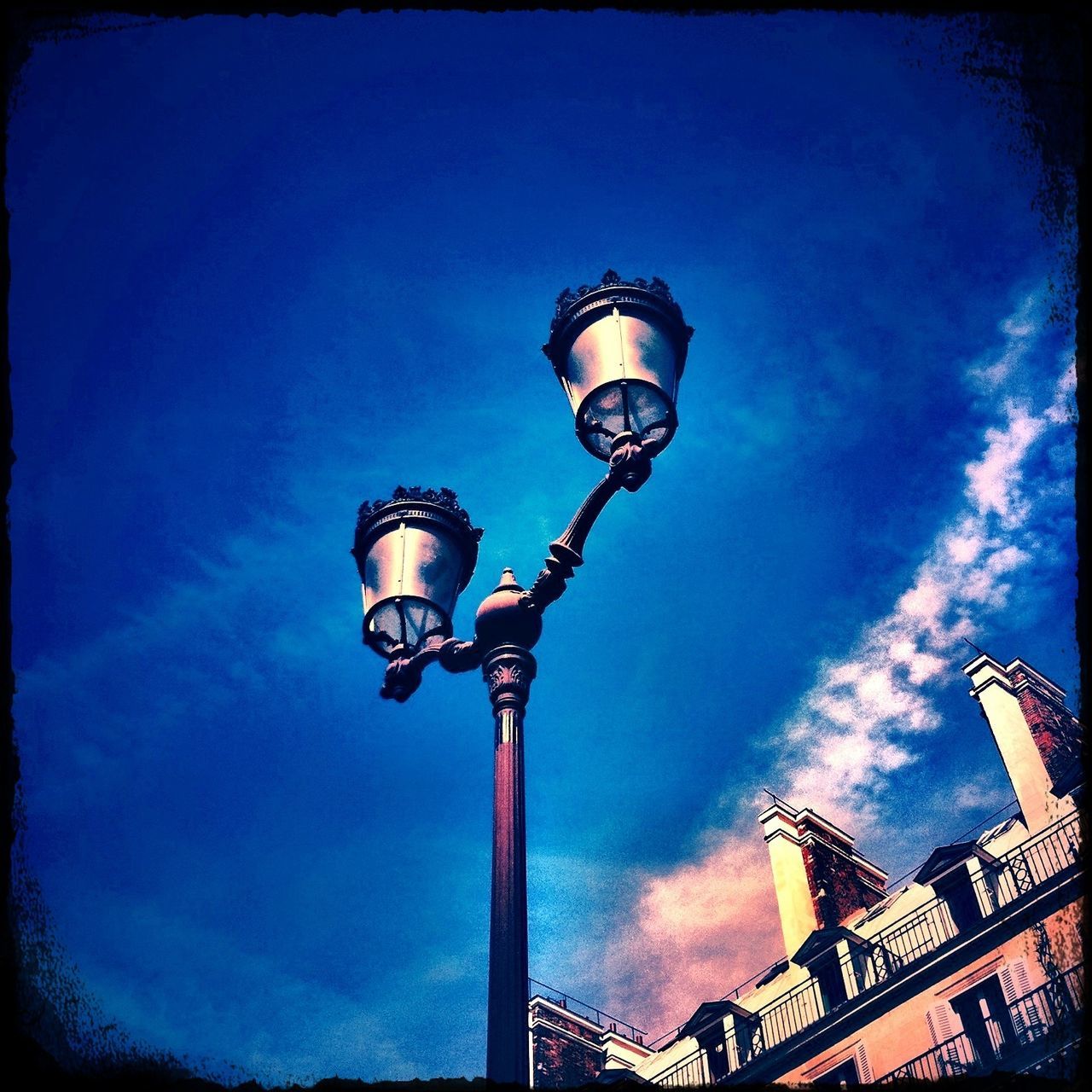 low angle view, built structure, architecture, sky, building exterior, tower, lighting equipment, communications tower, street light, tall - high, blue, cloud - sky, communication, auto post production filter, cloud, day, outdoors, transfer print, no people, fernsehturm