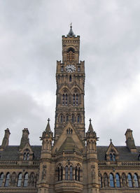 Low angle view of clock tower against sky