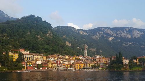 Scenic view of river and mountains against sky