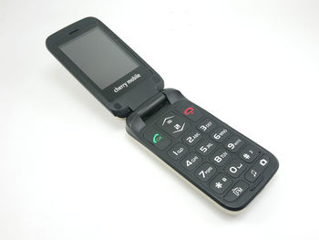 High angle view of mobile phone over white background