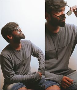 Young man wearing sunglasses sitting outdoors