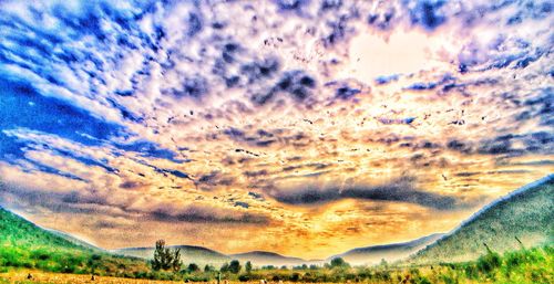 Scenic view of dramatic sky over landscape