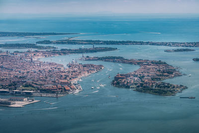 High angle view of city and sea against sky