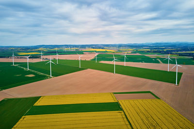 Wind generators over colorful agricultural fields. green energy development