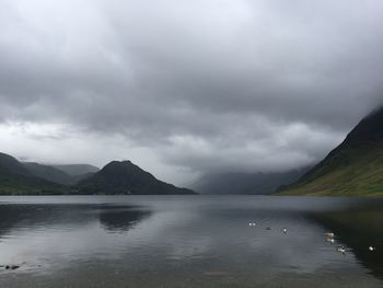 Scenic view of lake against cloudy sky