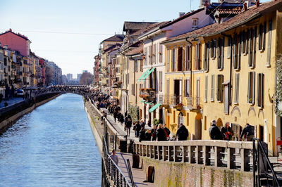 People on bridge in city