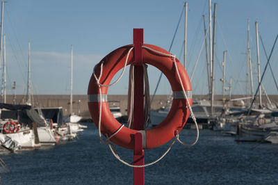 Boats moored in sea against clear sky