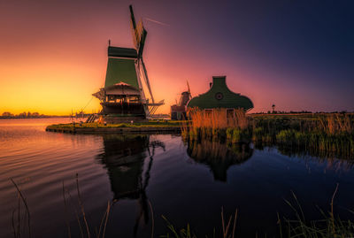 Reflection of building in lake during sunset