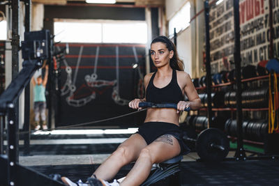 Young woman exercising in gym