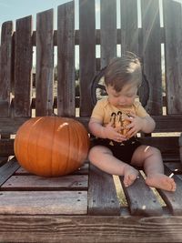 Baby boy holding a pumpkin