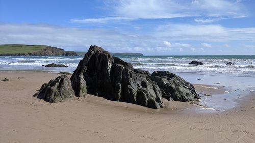 Panoramic view of rocks on beach against sky