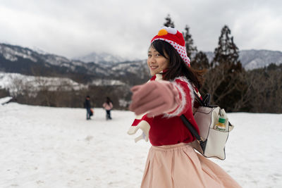 Woman standing on snow covered land