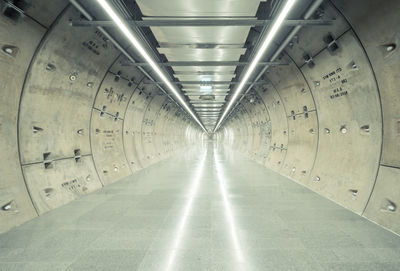 Empty illuminated underground walkway in building