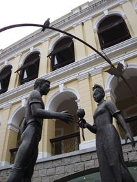 Low angle view of statue against sky