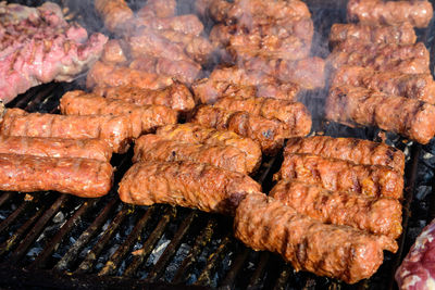 Grilled meat rolls called mici or mititei, traditional romanian barbeque grill food on the barbeque