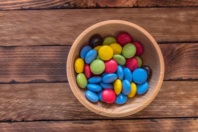 Directly above shot of multi colored candies in bowl on table