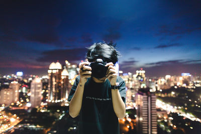 Man in city at night