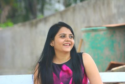 Smiling young woman looking away 