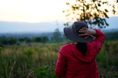 Full length of woman wearing hat standing on field