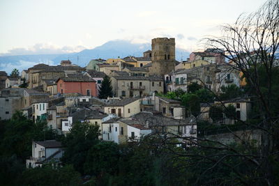 Houses in town against sky