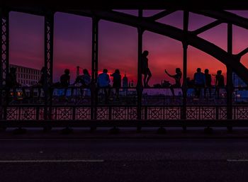 Silhouette people at observation point against sky