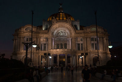 Group of people in illuminated building at night