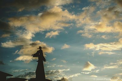 Low angle view of silhouette statue against sky