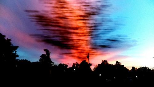 Silhouette trees against sky at night