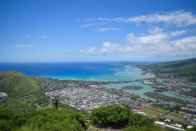 High angle view of sea and cityscape against sky