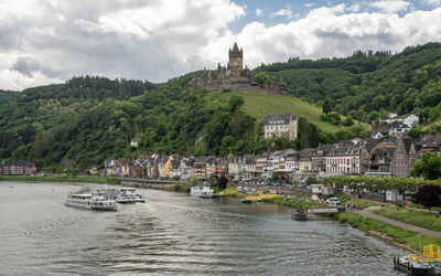 High angle view of townscape by river against sky