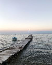 Scenic view of sea against clear sky during sunset