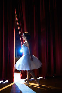 Woman standing in illuminated nightclub