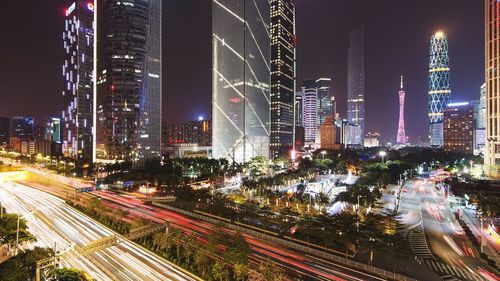 Illuminated cityscape against sky at night