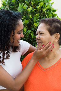 Granddaughter touching her grandmother's face