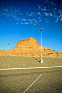 Road against clear blue sky