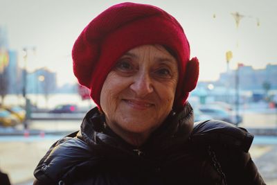 Portrait of senior woman wearing knit hat in city