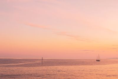 Lone boat in calm sea against the sky